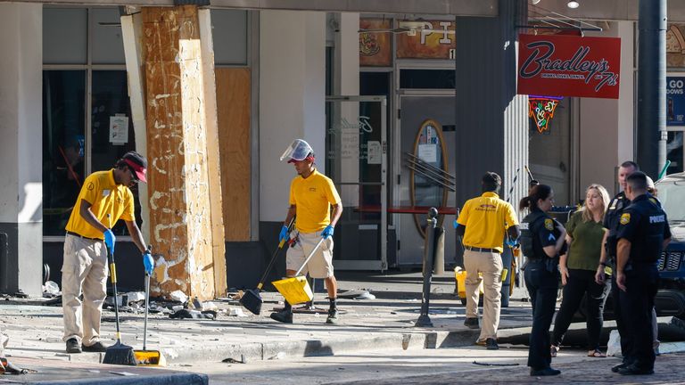 People clean up the damage from the crash. Pic: Jefferee Woo/Tampa Bay Times/AP