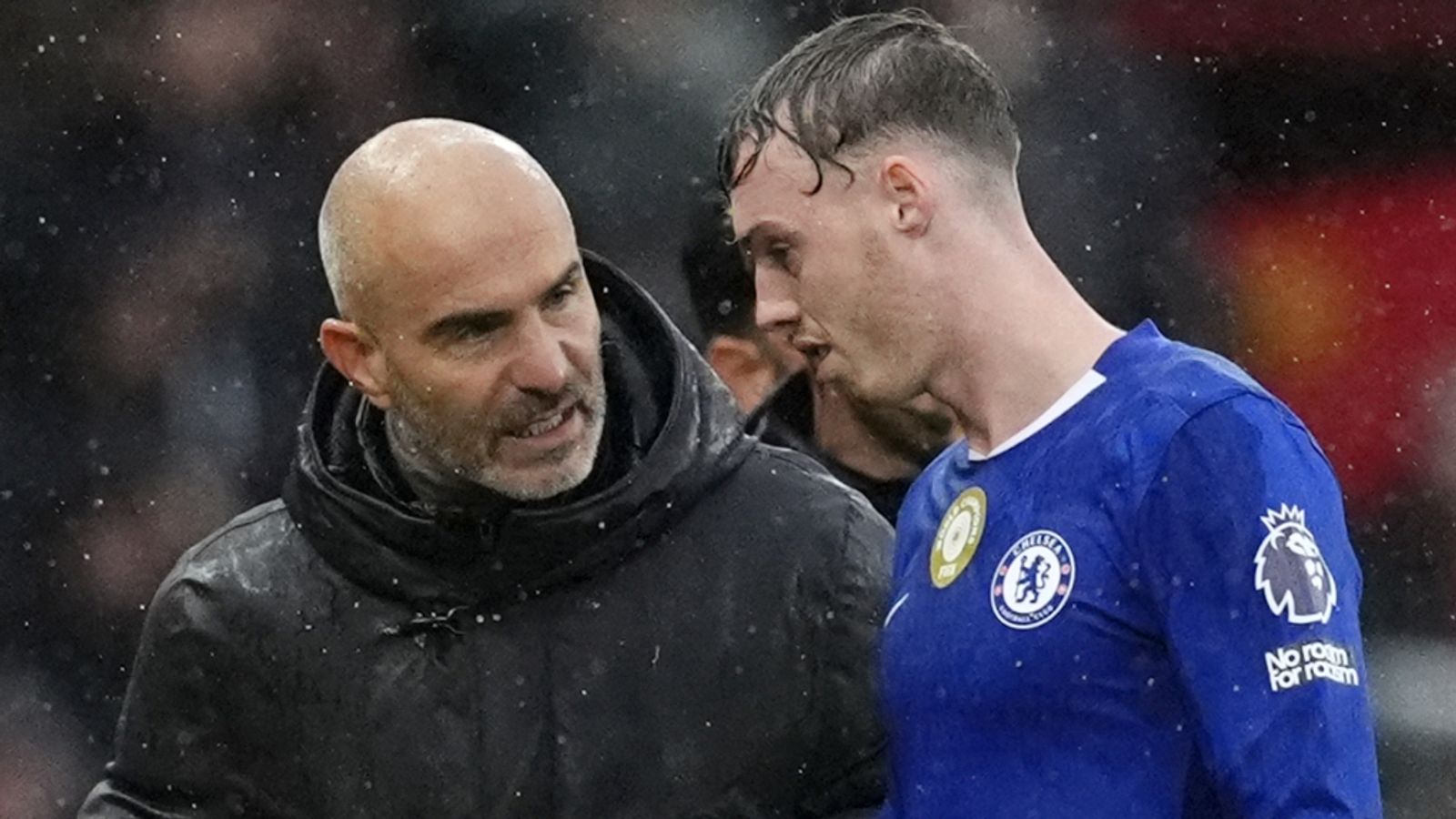 Cole Palmer (right) speaks with Chelsea head coach Enzo Maresca after injuring his groin in September