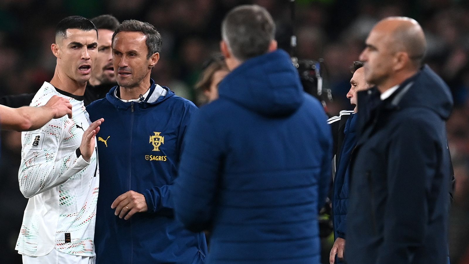 Cristiano Ronaldo is restrained by staff after being sent off in Portugal's match against Republic of Ireland