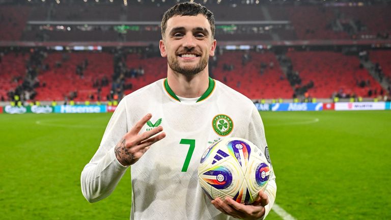 Troy Parrott celebrates with the match ball after scoring a hat-trick against Hungary