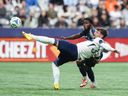 Vancouver Whitecaps' Tristan Blackmon (front) and San Diego FC's Alex Mighten vie for the ball during the first half of an MLS soccer match, in Vancouver on June 25, 2025.