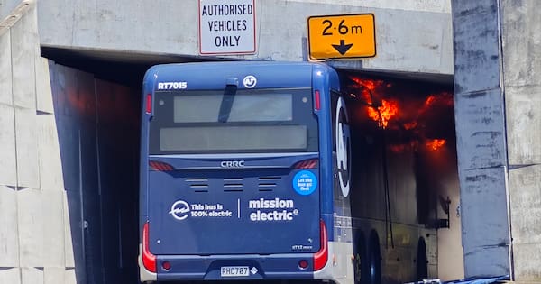 Bus on fire after colliding with overpass in Auckland's North Shore