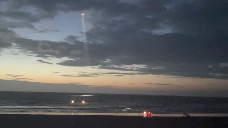 The Eagle helicopter and surf lifeguards work to rescue the missing surfer. 