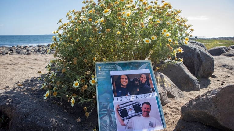 The photos of foreign surfers who disappeared are displayed on a poster on the beach in Ensenada, Mexico, May 5, 2024.