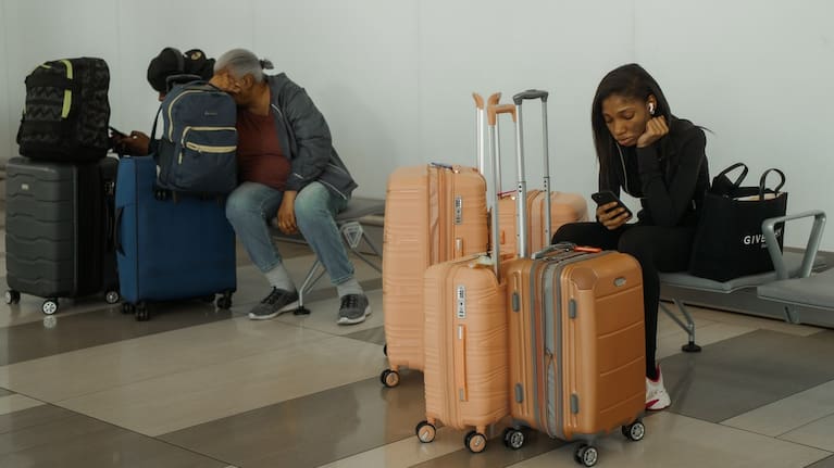 Travellers wait at LaGuardia International Airport in New York.