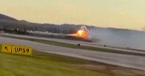 An image capture of video footage distributed by the Associated Press shows flames appearing to come from the left wing of a UPS plane before it crashed in Louisville, Kentucky, Nov. 4, 2025.