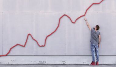 Person looking at a stock chart on a wall and pointing to it going up and to the right.