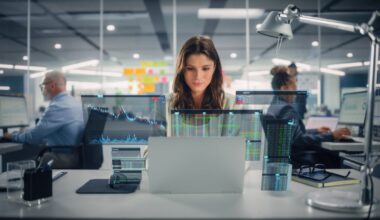 An investor studies multiple stock charts across several screens.