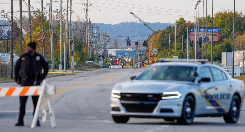 Louisville Metro Police Department officers blocked off the road leading to the crash scene.
