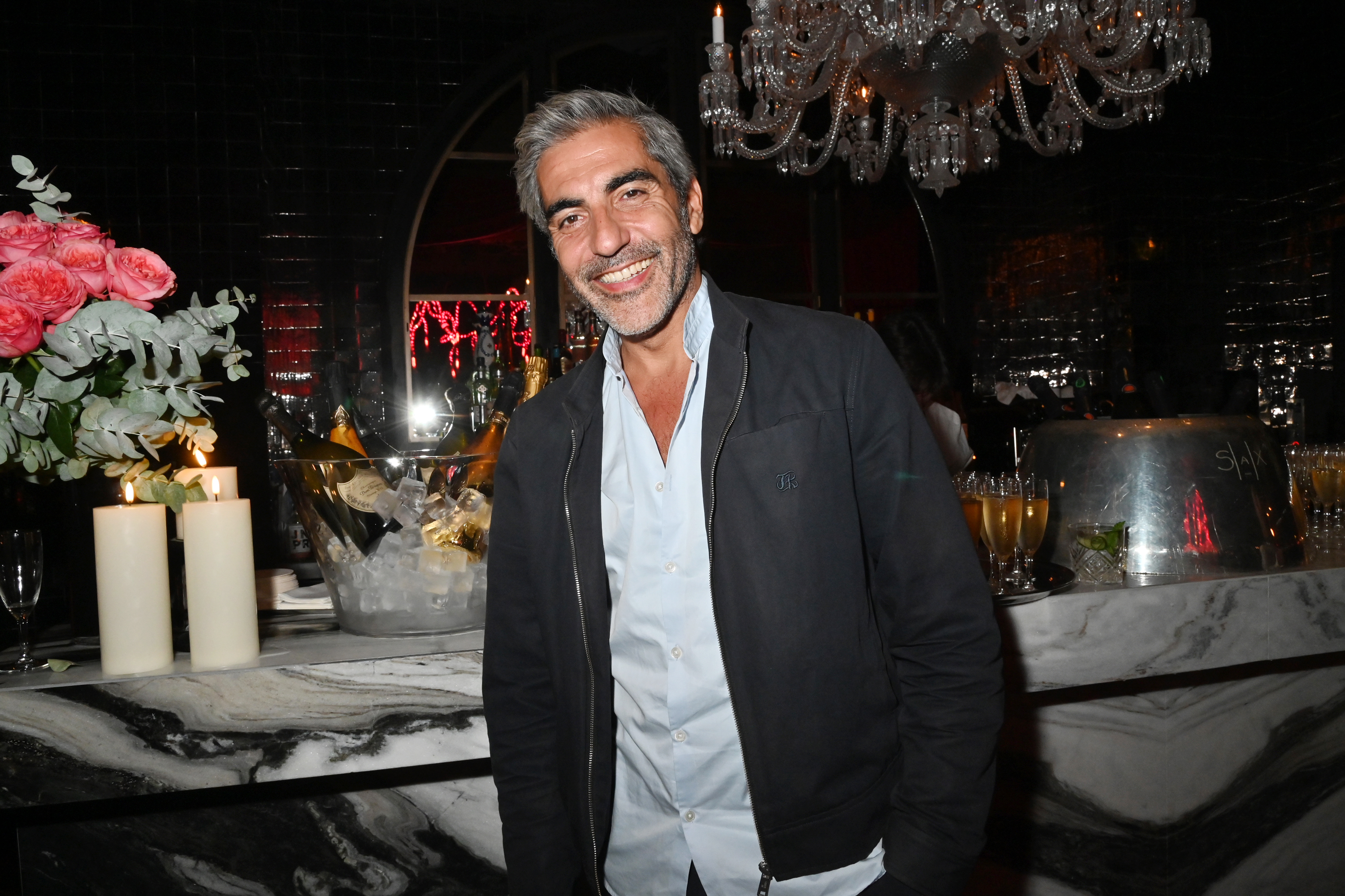 Ary Abittan smiling at the Sax 54 Party at Hotel Sax Paris.