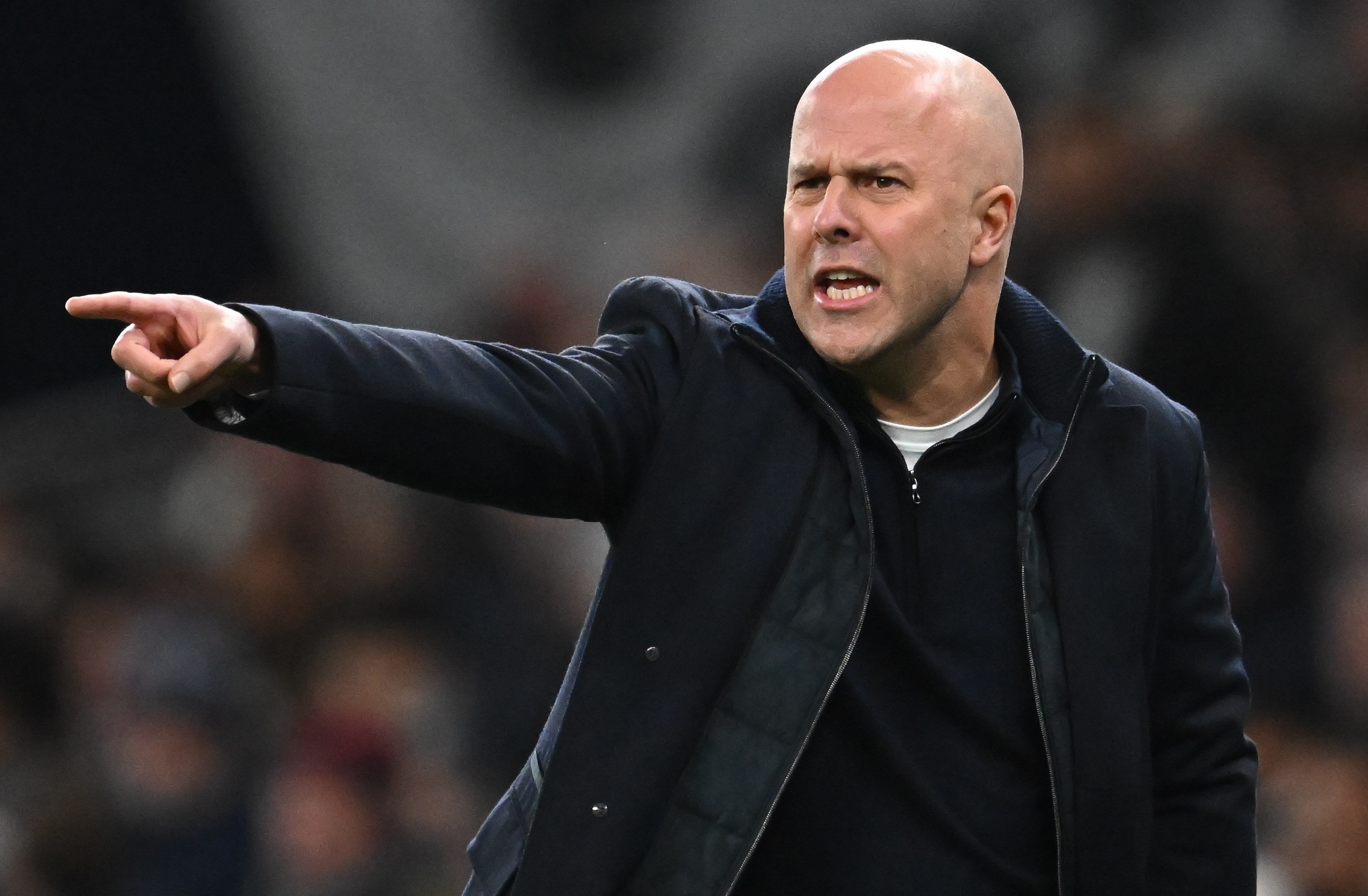 Liverpool's head coach Arne Slot pointing and yelling during a match.