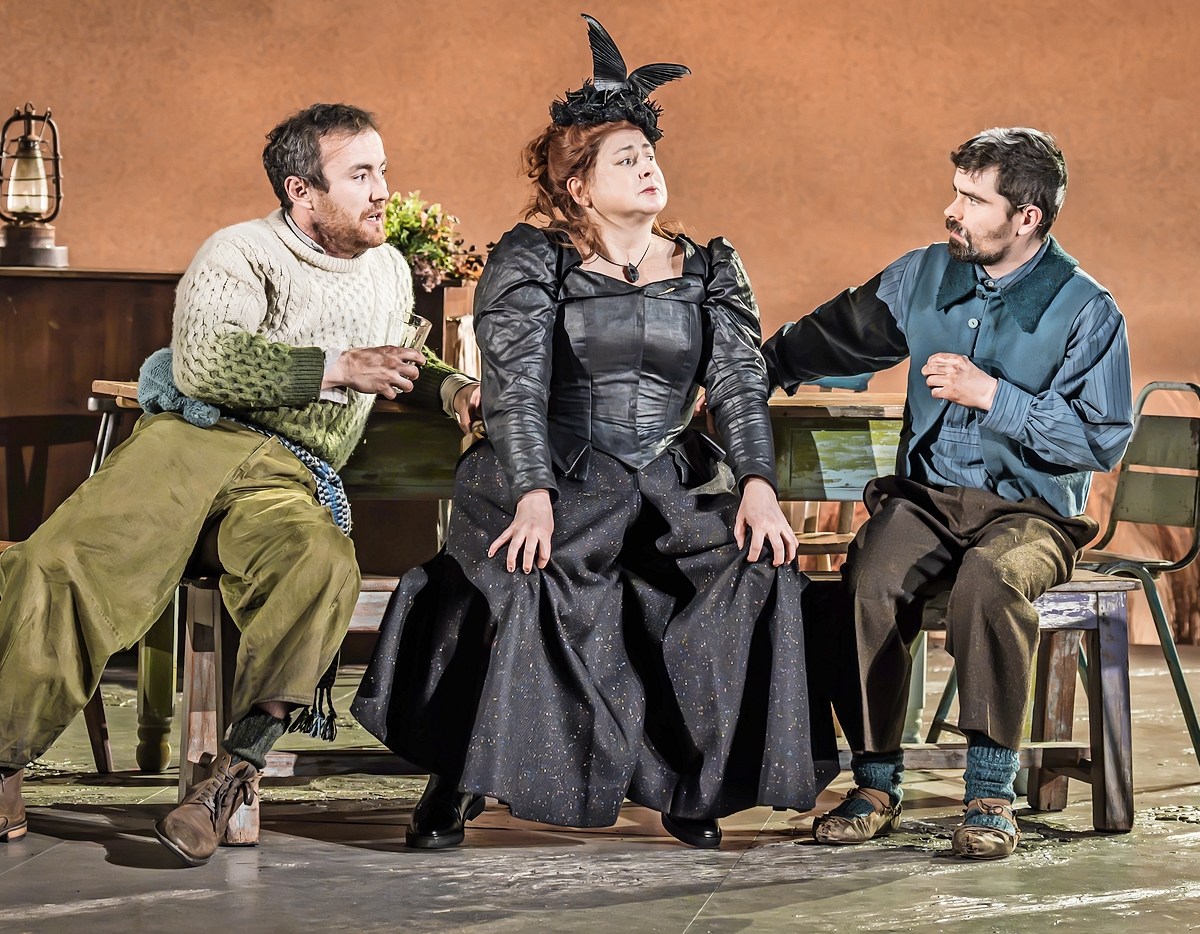 Naoise Dunbar as Jimmy Farrell, Siobhán McSweeney as Widow Quin, and Matthew Forrest as Philly Cullen in "The Playboy of the Western World" at the National Theatre.