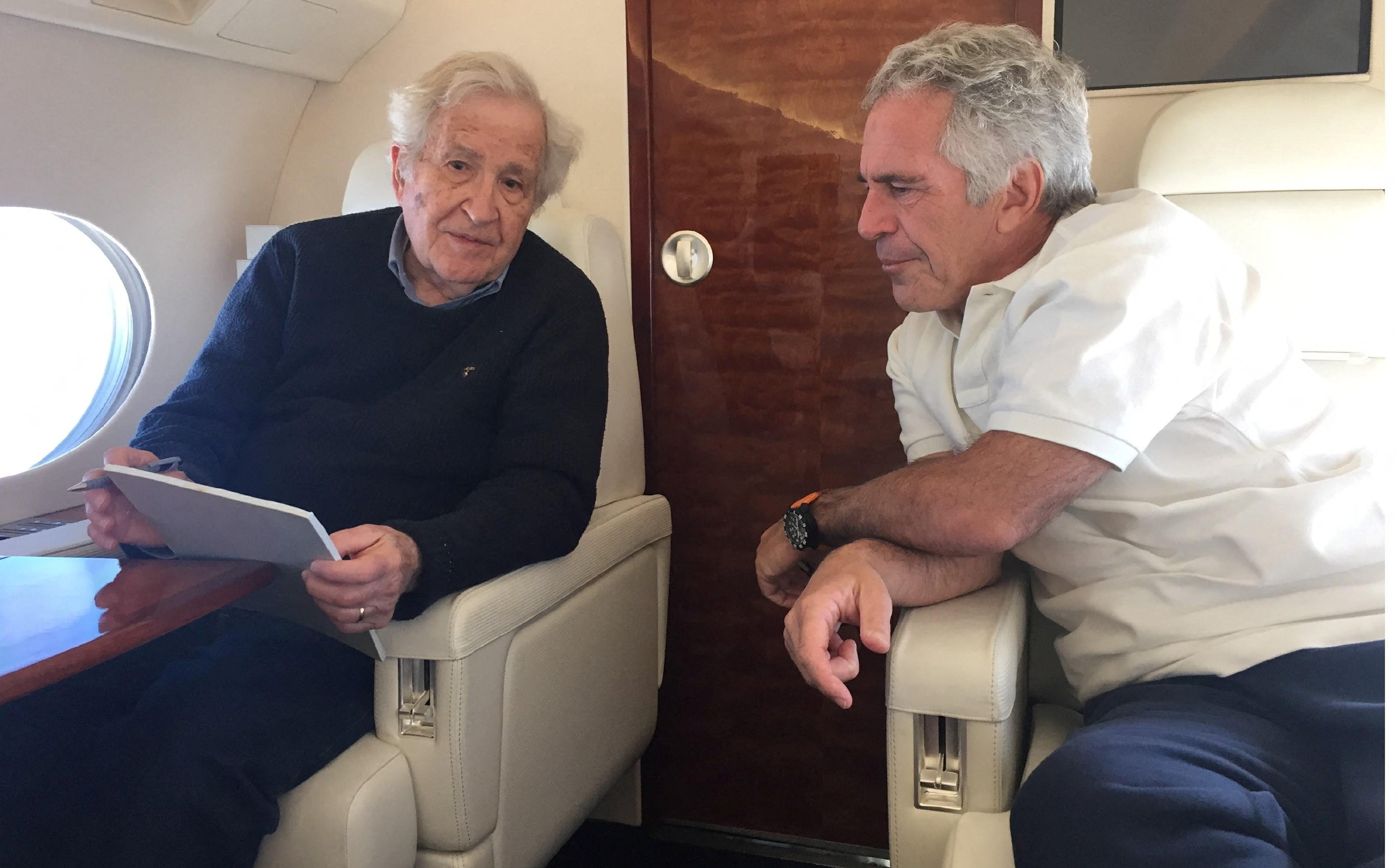 Noam Chomsky seated across from Jeffrey Epstein on a plane.