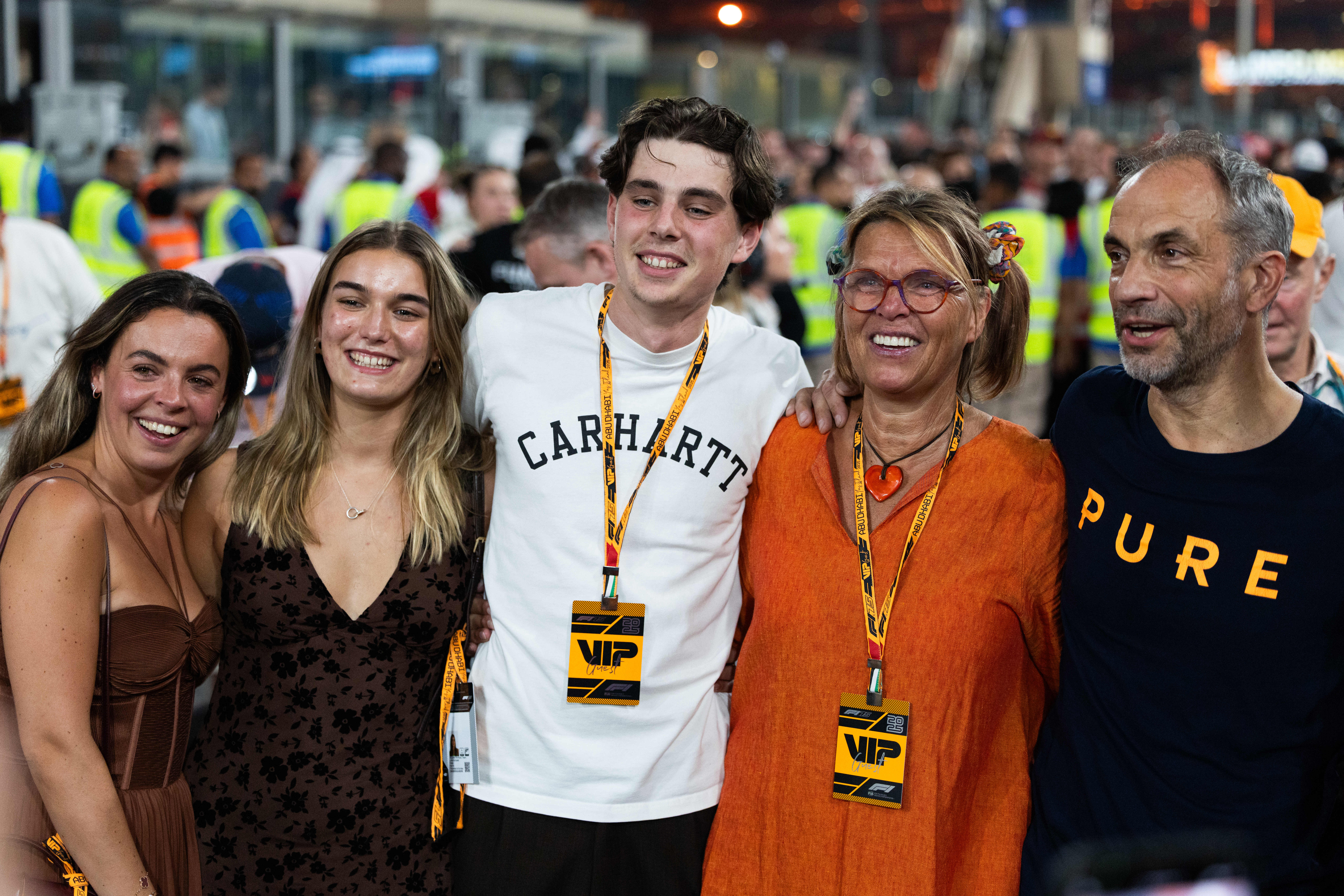 Lando Norris' family (Savannah Norris, Cisca Norris, Callum Fred Harvey, Cisca Norris, and Adam Norris) on the grid after the Abu Dhabi Grand Prix.