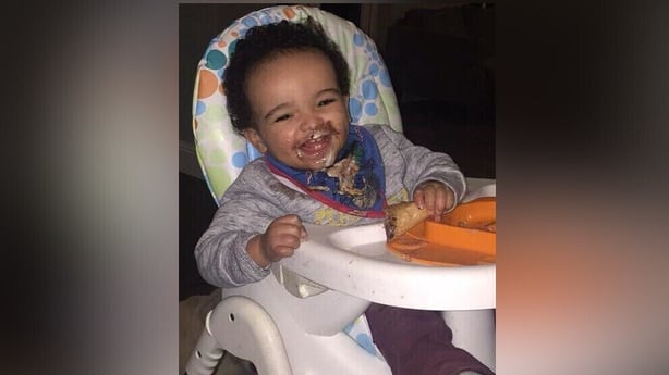Smiling Daniel Aruebuose in a highchair