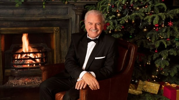 Marty Whelan in front of the fire
