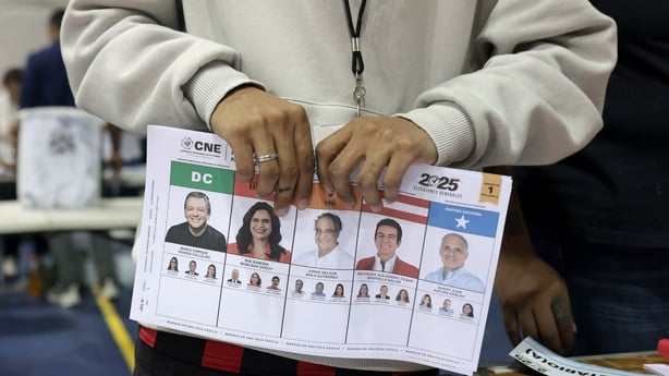 An election official holds an unmarked ballot