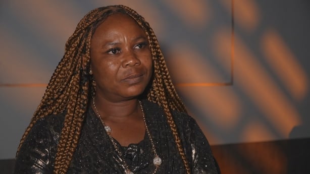 Syvia stands facing slightly off camera