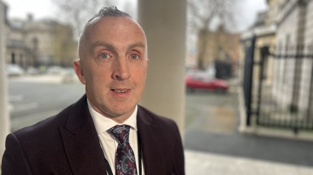 Donal Kavanagh stands in an outdoor area.