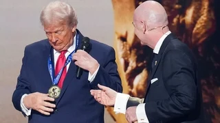 U.S. President Donald Trump receives the FIFA Peace Prize from FIFA President Gianni Infantino (R) for the FIFA World Cup 2026 Official Draw at the John F. Kennedy Center for the Performing Arts December 05, 2025 in Washington, DC. The 2026 FIFA World Cup