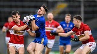 Rickey Barrett of St Finbarr's is tackled by Aidan O'Connor, left, and Matthew Flaherty of Daingean Uí Chúis during the AIB Munster GAA Football Senior Club Championship final match between Daingean Uí Chúis and St Finbarr's