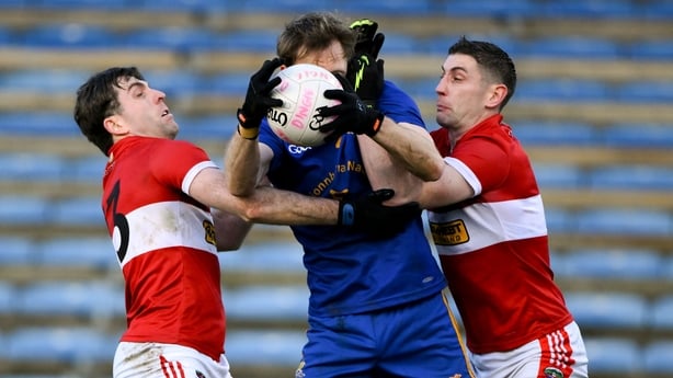 7 December 2025; Sam Ryan of St Finbarr's is tackled by Conor Geaney, left, and Paul Geaney of Dingle during the AIB Munster GAA Football Senior Club Championship final match between Dingle and St Finbarr's at FBD Semple Stadium in Thurles, Tipperary. Photo by Brendan Moran/Sportsfile