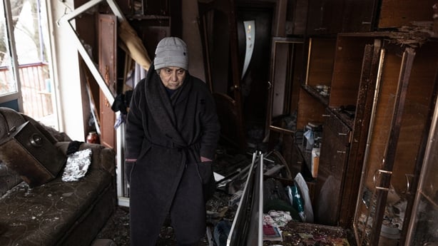 A local woman shows her damaged home after a Russian shelling of a residential area in Druzhkivka, Ukraine