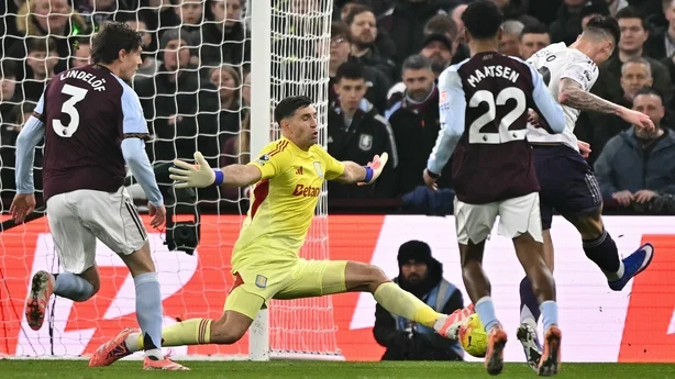 ston Villa's Argentinian goalkeeper #23 Emiliano Martínez (2L) saves a shot from Manchester United's Slovenian striker #30 Benjamin Sesko (R) during the English Premier League football match between Aston Villa and Manchester United at Villa Park in Birmingham, central England on December 21, 2025. 