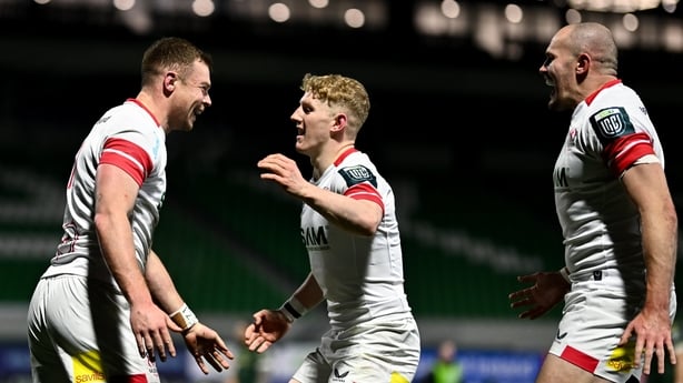 27 December 2025; Zac Ward of Ulster celebrates with teammates, including Conor McKee, centre, and Jacob Stockdale, right, after scoring their side's second try during the United Rugby Championship match between Connacht and Ulster at Dexcom Stadium in Galway. Photo by Ben McShane/Sportsfile