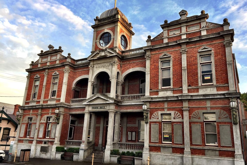 Rainbow posters appear in the windows at Castlemaine