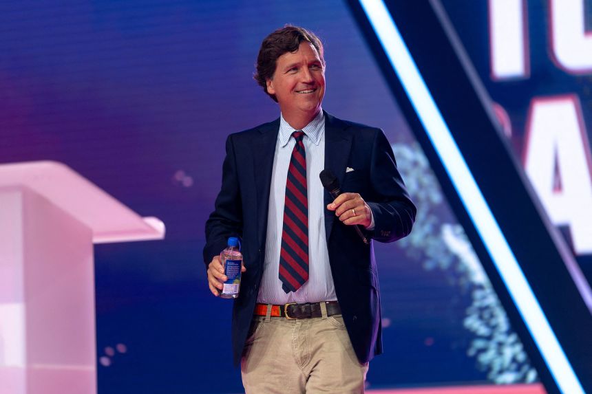 Tucker Carlson takes the AmericaFest stage on Thursday.