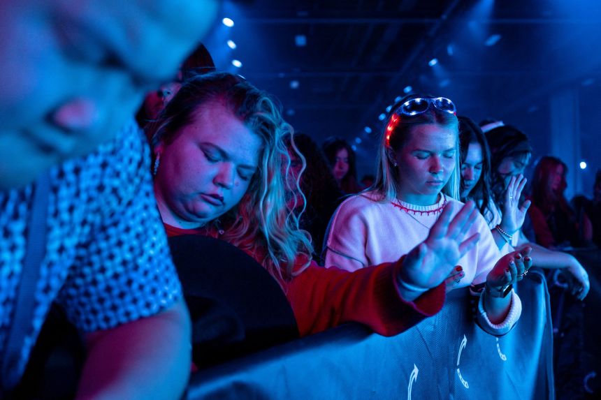 Attendees pray during AmericaFest in Phoenix on Thursday.