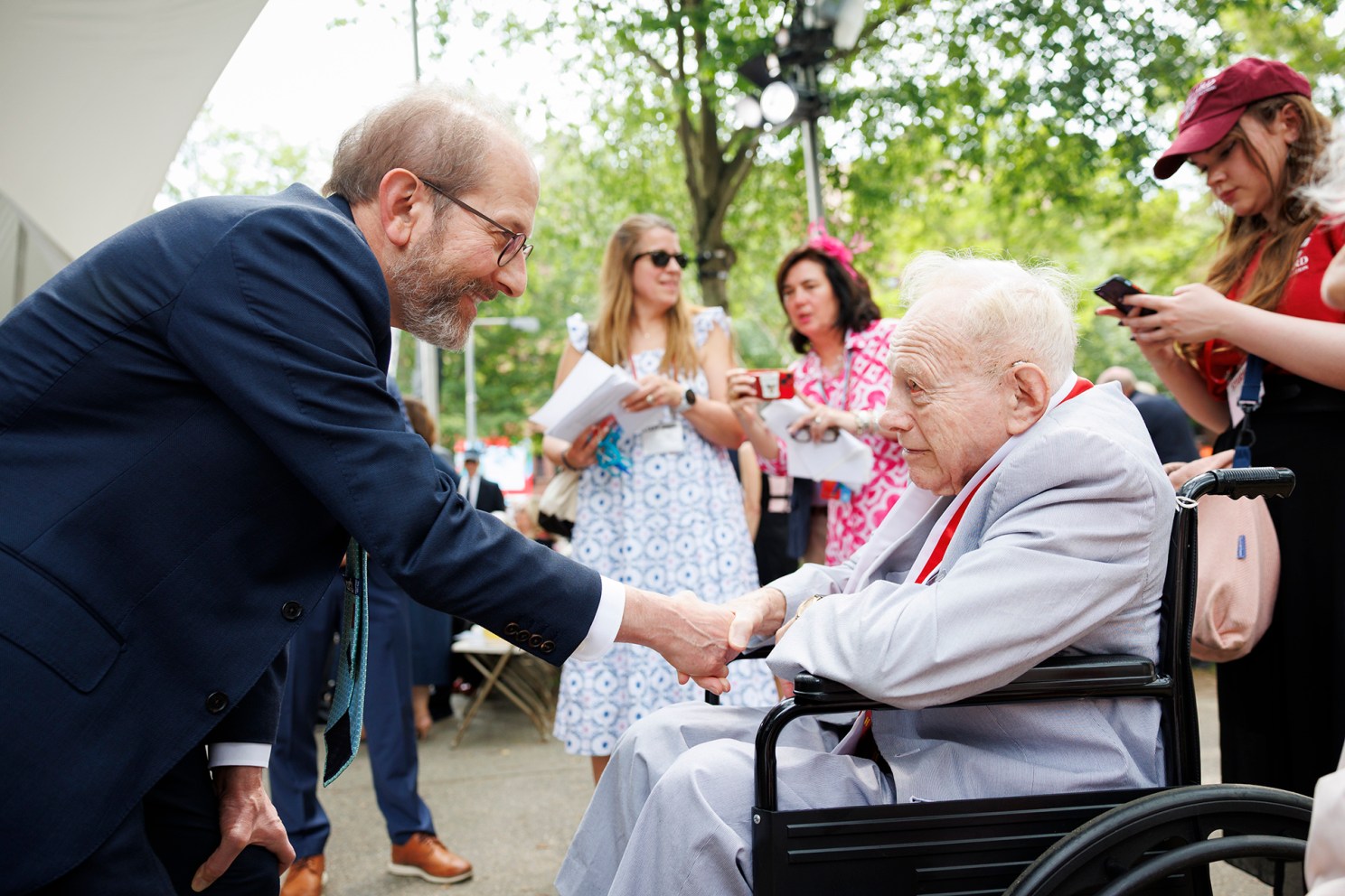 Alan Garber greets eldest male alumni Stan Karson at 2025 Harvard Alumni Day celebration.