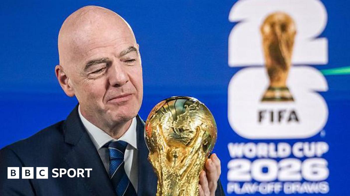 Fifa president Gianni Infantino holding the World Cup
