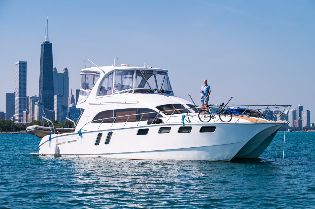 Matt Jonkman poses for a portrait aboard his catamaran power boat anchored off the wall near Navy Pier on Lake Michigan on Sept. 18, 2025.