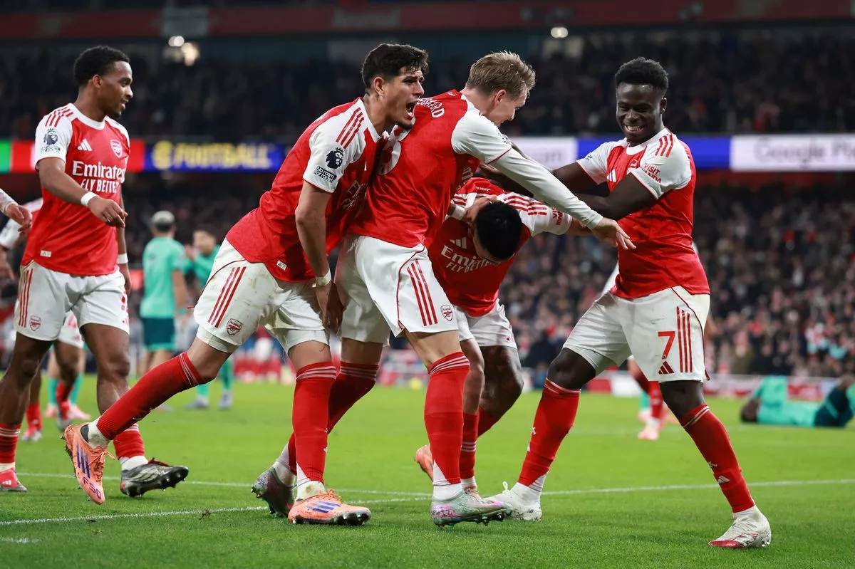 Arsenal players celebrate scoring a late goal against Wolves in the Premier League