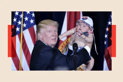AFP via Getty Images Donald Trump holds a baby during a rally 