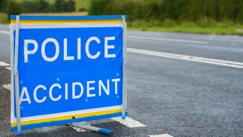 Getty Images A police accident sign sitting on a road - the words POLICE ACCIDENT are written in white capital letters on a blue background