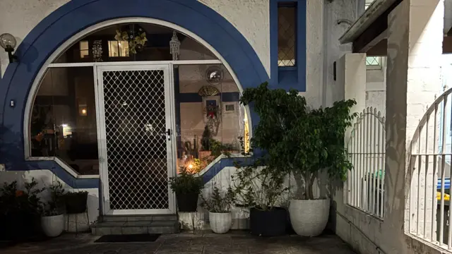 A candle burns in the window of a home in Bondi Beach in support of Jewish Australians after the attack.