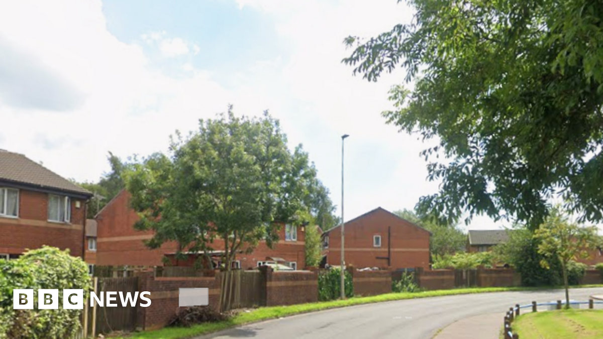 Modern red brick houses and trees line Galligreaves Way in Blackburn as it curves round towards Heatley Close.