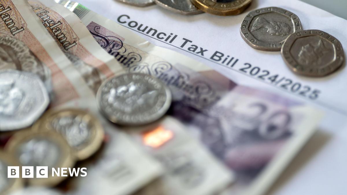 Two £10 notes and a £20 note are stacked up on top of a council tax bill, along with a handful of coins.