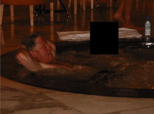 Clinton features prominently in the files, seen here relaxing in what appears to be a hot tub
