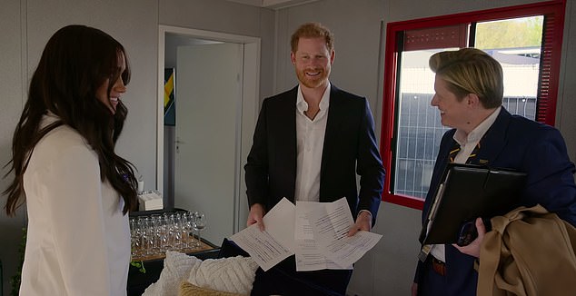 Holt (right with Harry and Meghan) has been running the Sussexes's Archewell charity since 2021