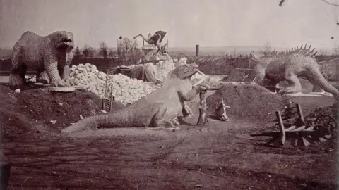 Philip H Delamotte via Heritage Art via Getty Images 'Models of Extinct Animals', Crystal Palace, Sydenham, 1852-1854. Taken during the progress of the works, by desire of the directors, by Philip H Delamotte. Together with a list of the directors and officers of the company, etc". [London, 1855]. Creator: Philip Henry Delamotte. (Photo by Heritage Art/Heritage Images via Getty Images)