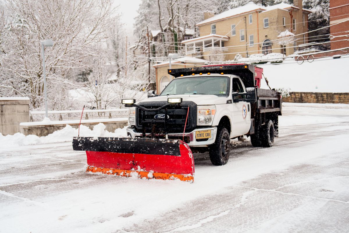 A snow plow is shown on the Morgantown Campus.