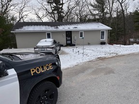 OPP cruisers are parked in front of a small home in Lambton Shores