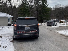 OPP cruisers are parked in front of a small home in Lambton Shores