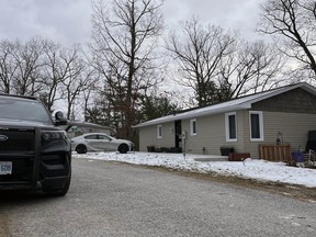 OPP cruisers are parked in front of a small home in Lambton Shores