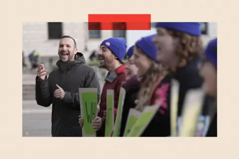 PA Wire Green Party leader Zack Polanski stands in a line with other campaigners 