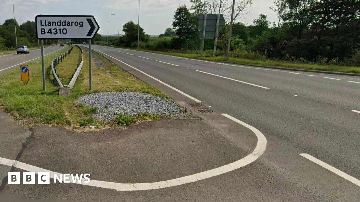 A sign on the A48 dual carriageway indicating the turn in for Llanddarog